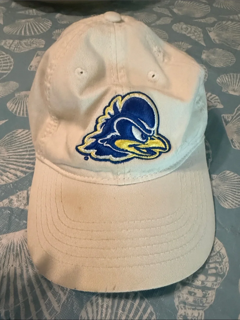 White Hat with Blue and Yellow Bird Logo